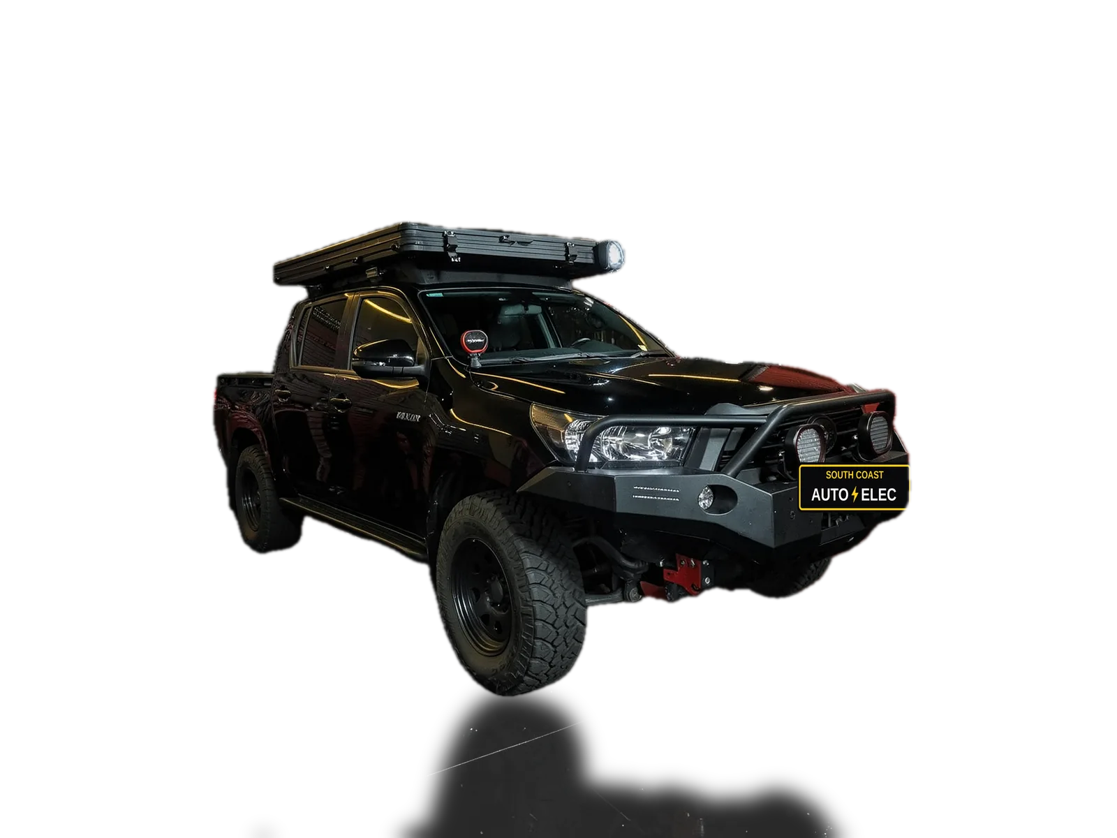 Hilux touring build by South Coast & Canberra Auto Electrics with its lights on